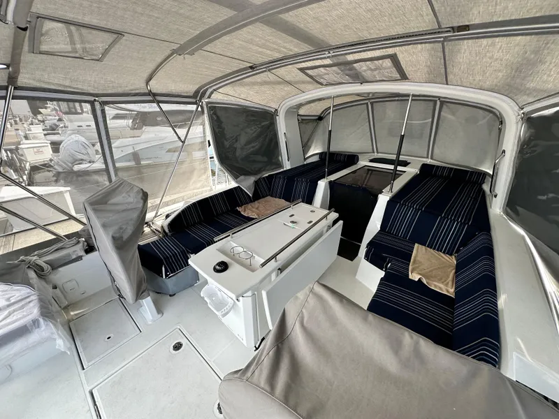 Slide: The Image of Interior of 2022 Beneteau Oceanis 46.1 yacht with striped seating and covered deck. - 12