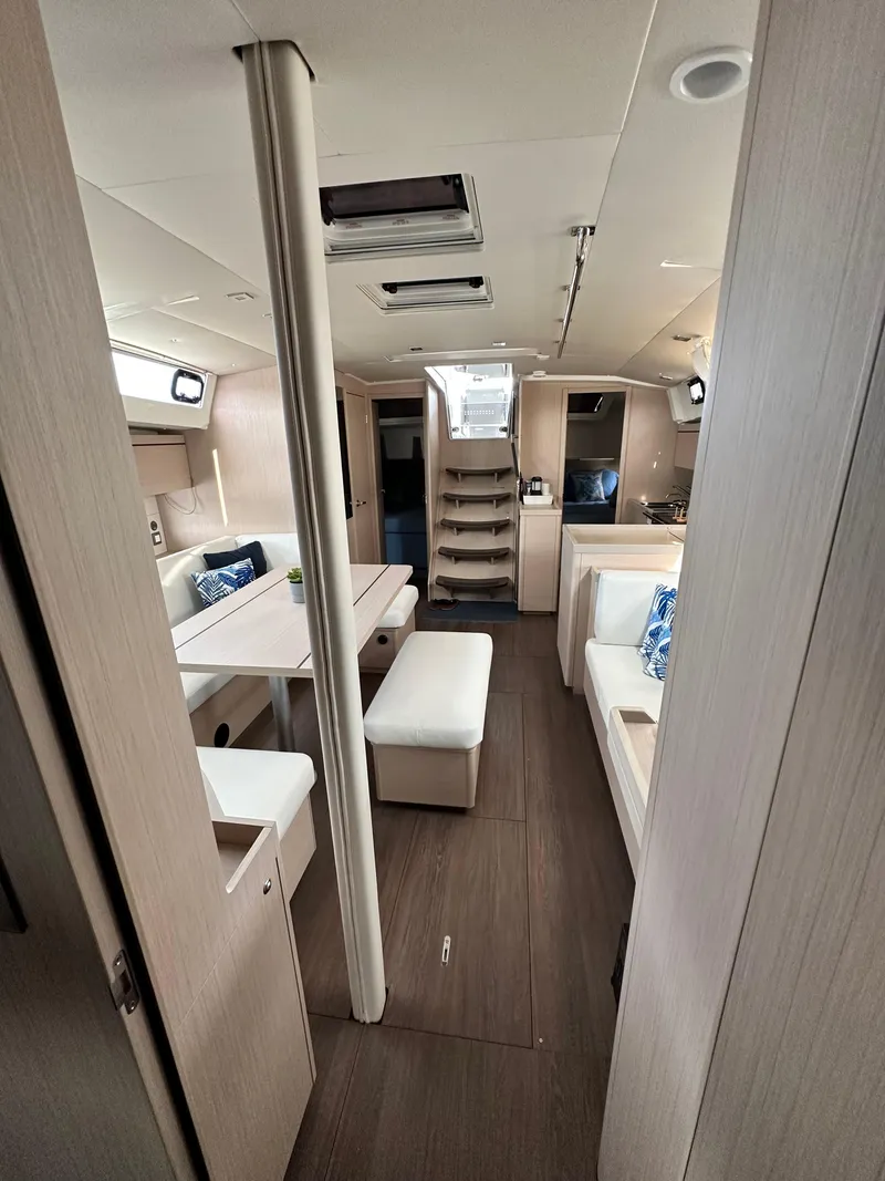 Slide: The Image of Interior of 2022 Beneteau Oceanis 46.1 yacht, featuring modern seating and wooden flooring. - 42