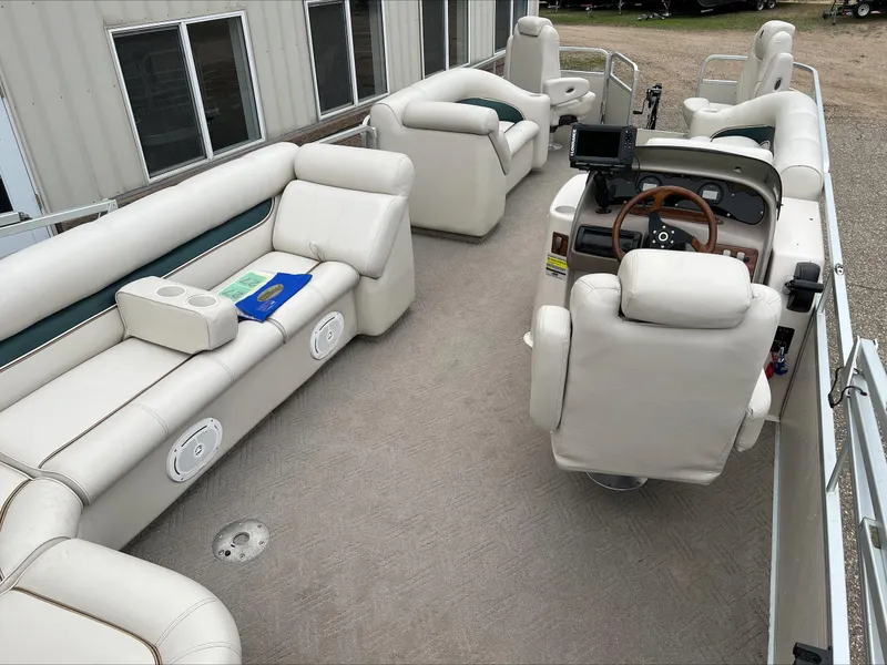 Slide: The Image of 2003 Premier 250 Escapade pontoon boat with spacious seating and modern helm. - 3