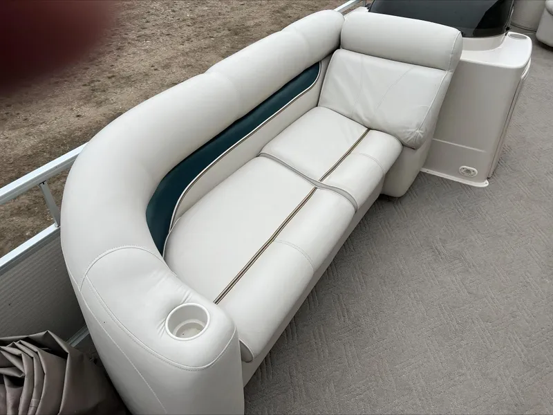 Slide: The Image of 2003 Premier 250 Escapade boat with white cushioned seating and cup holder. - 4