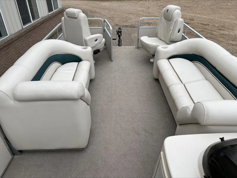 Slide: The Image of 2003 Premier 250 Escapade boat interior with white seating and spacious layout. - 5