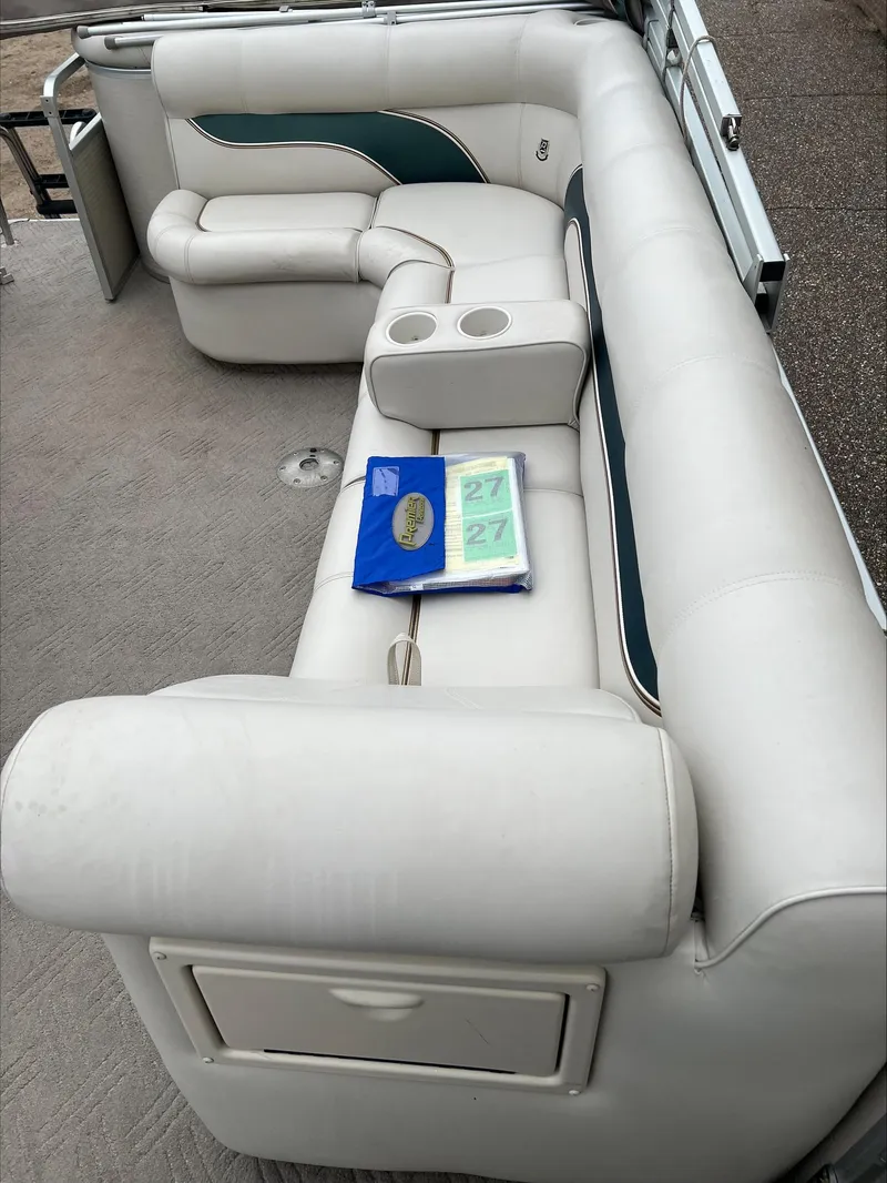Slide: The Image of 2003 Premier 250 Escapade boat interior with white seating and cup holders. - 7
