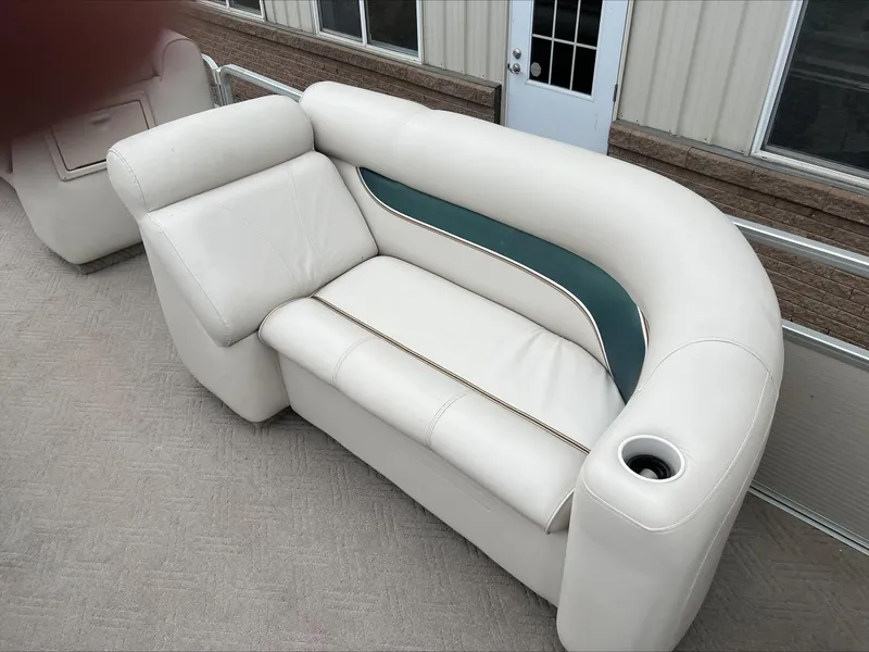 Slide: The Image of 2003 Premier 250 Escapade boat seating with white upholstery and cup holder. - 9
