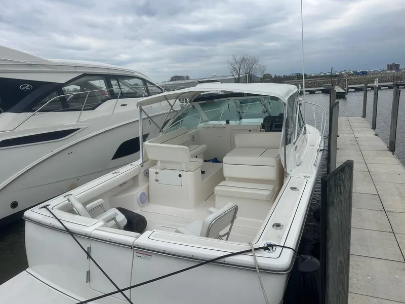 Slide: The Image of 2006 Tiara Yachts 2900 Coronet docked, showcasing spacious deck and sleek design. - 3