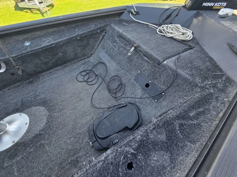 Slide: The Image of 2008 Xpress XP16PF Stick-Steer boat interior with Minn Kota trolling motor and coiled rope. - 10