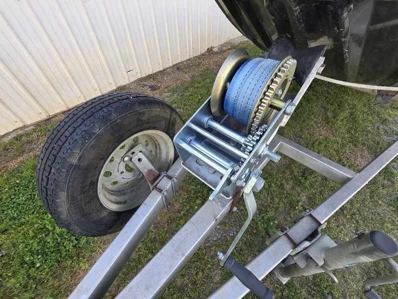 Slide: The Image of Trailer winch and wheel of 2008 Xpress XP16PF Stick-Steer boat on grass. - 12