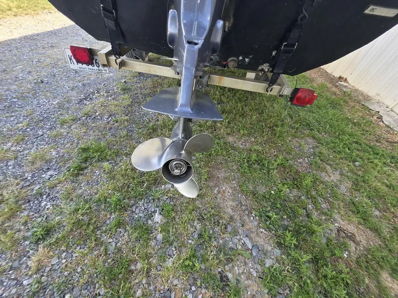 Slide: The Image of 2008 Xpress XP16PF Stick-Steer boat propeller on trailer, parked on gravel and grass. - 15