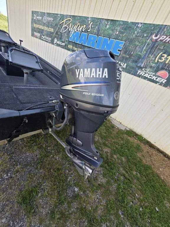 Slide: The Image of 2008 Xpress XP16PF Stick-Steer boat with Yamaha 50HP outboard motor, parked near Bryan's Marine. - 16