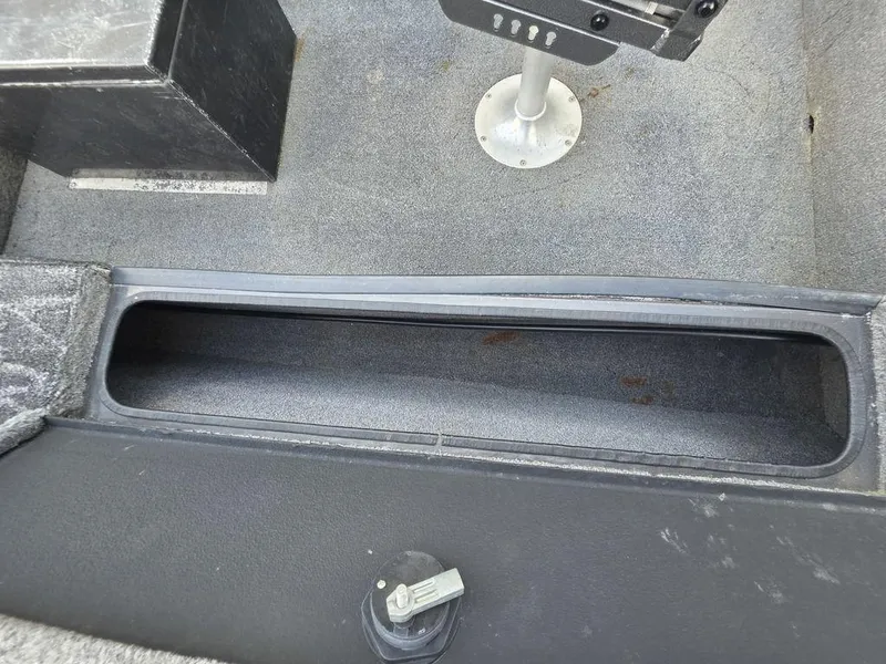 Slide: The Image of 2008 Xpress XP16PF Stick-Steer boat interior with storage compartment and seat base. - 17