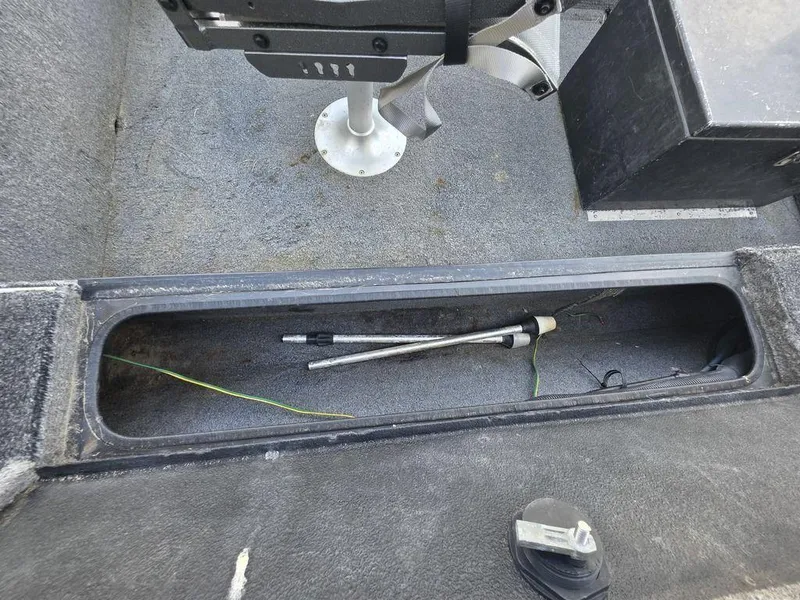 Slide: The Image of 2008 Xpress XP16PF Stick-Steer boat interior with storage compartment and fishing rod. - 7