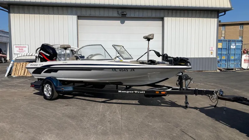 Slide: The Image of 2004 Ranger 180 Reata boat on trailer outside industrial building. - 0