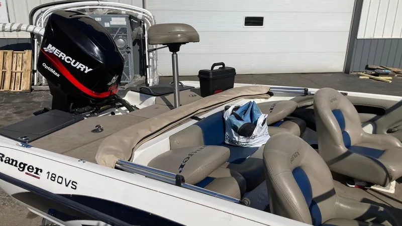 Slide: The Image of 2004 Ranger 180 Reata boat with Mercury outboard motor, beige and blue seating. - 3
