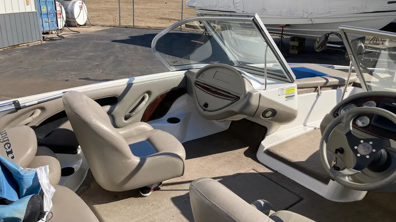 Slide: The Image of 2004 Ranger 180 Reata boat interior with beige seating and steering wheel. - 4