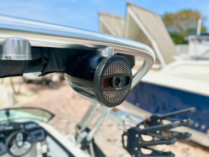 Slide: The Image of 2023 MasterCraft NXT21 boat with mounted speaker on metal frame, sunny day background. - 10