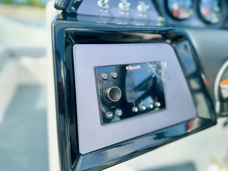 Slide: The Image of 2023 MasterCraft NXT21 boat dashboard with Klipsch audio system controls. - 17