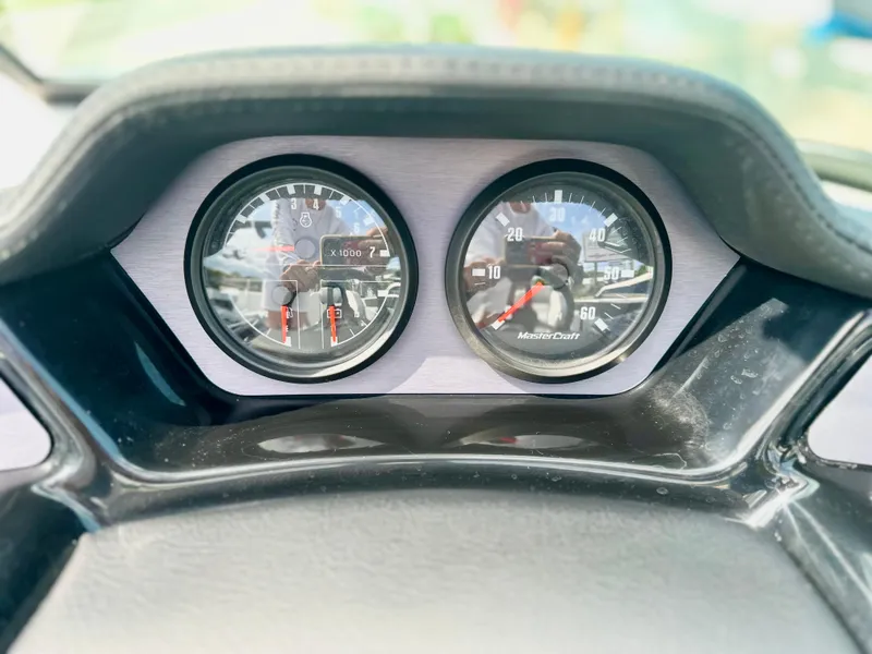 Slide: The Image of Dashboard gauges of a 2023 MasterCraft NXT21 boat, displaying speed and RPM. - 19