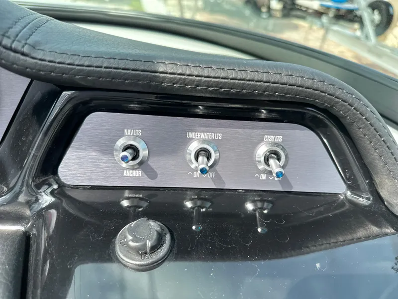 Slide: The Image of Control panel of 2023 MasterCraft NXT21 boat with navigation and underwater light switches. - 20