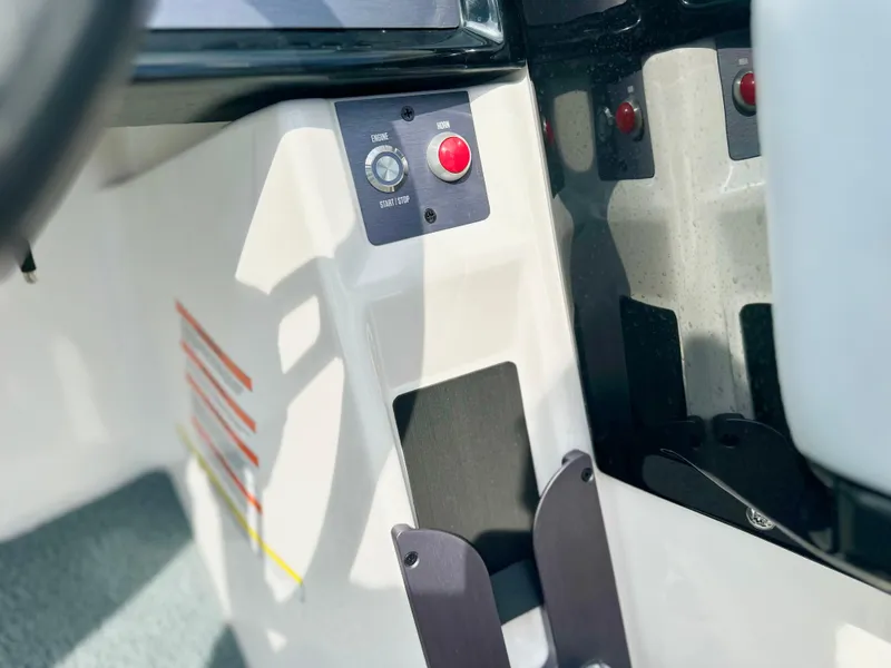 Slide: The Image of Control panel of 2023 MasterCraft NXT21 boat with start button and switches. - 22
