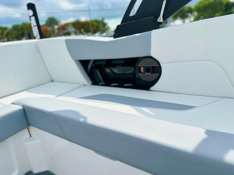 Slide: The Image of 2023 MasterCraft NXT21 boat interior with sleek white and gray seating. - 32
