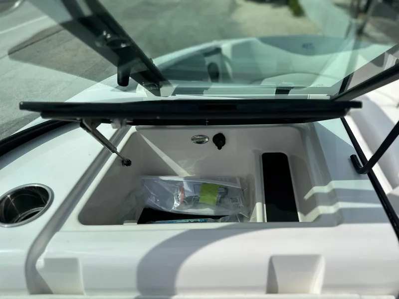 Slide: The Image of Open storage compartment on 2023 MasterCraft NXT21 boat. - 35