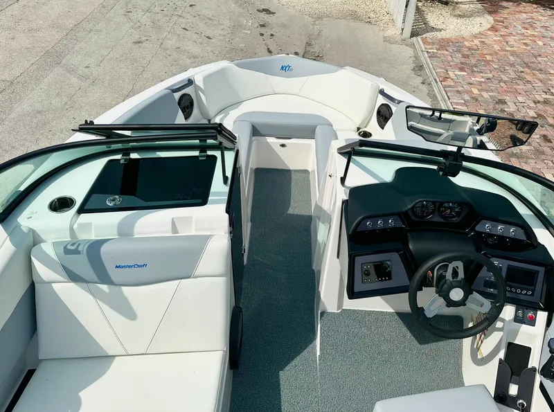 Slide: The Image of 2023 MasterCraft NXT21 boat interior with sleek dashboard and seating. - 38
