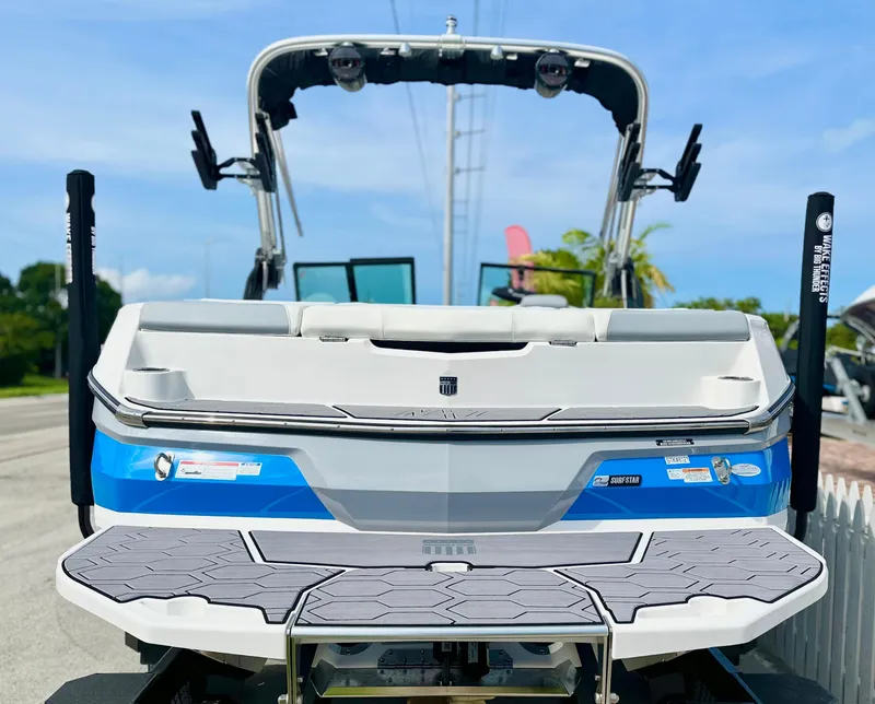 Slide: The Image of 2023 MasterCraft NXT21 boat, rear view, showcasing sleek design and swim platform. - 4