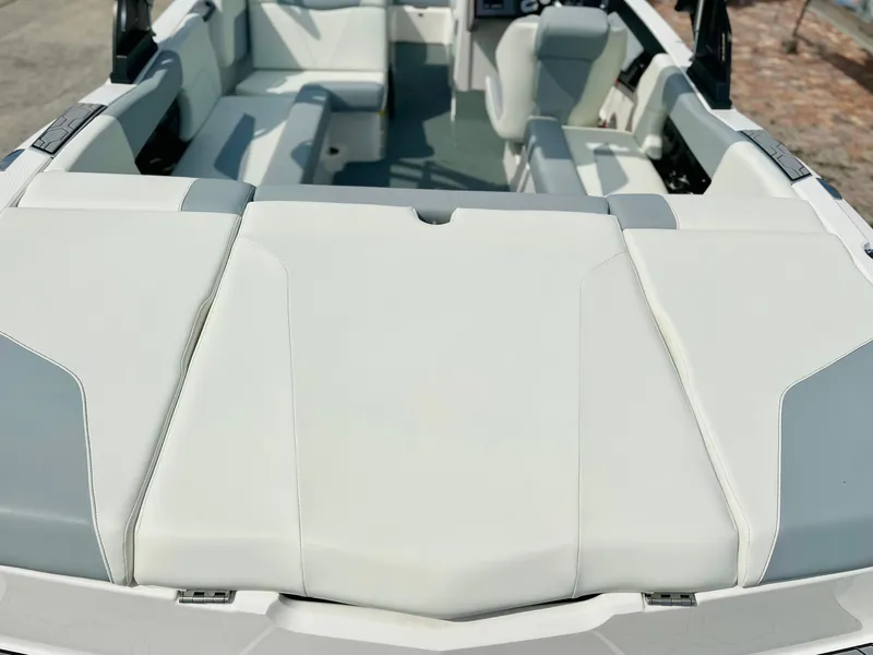 Slide: The Image of 2023 MasterCraft NXT21 boat interior with white seating and spacious layout. - 9