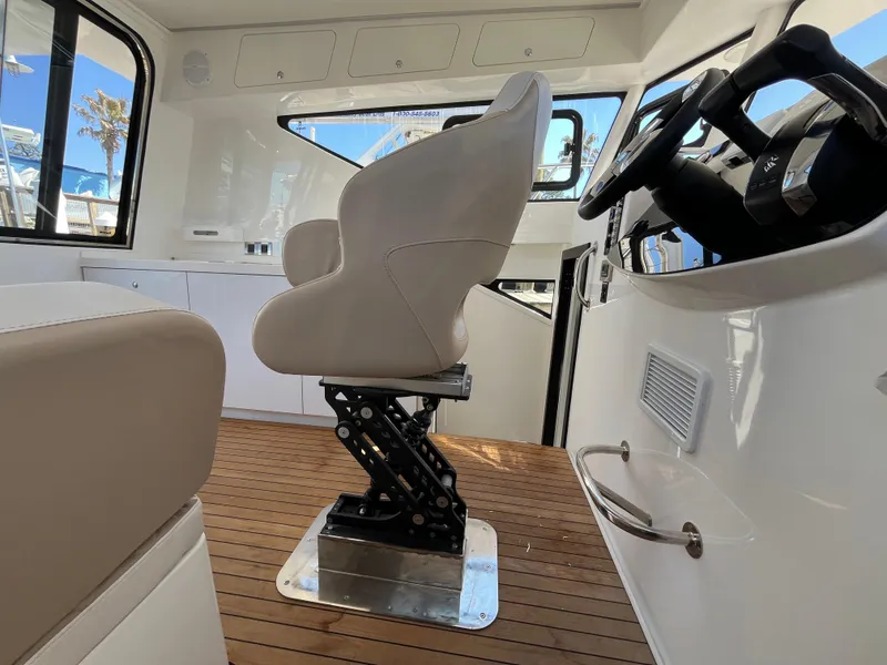 Slide: The Image of 2024 Tuna catamaran interior with modern helm seat and wooden flooring. - 17