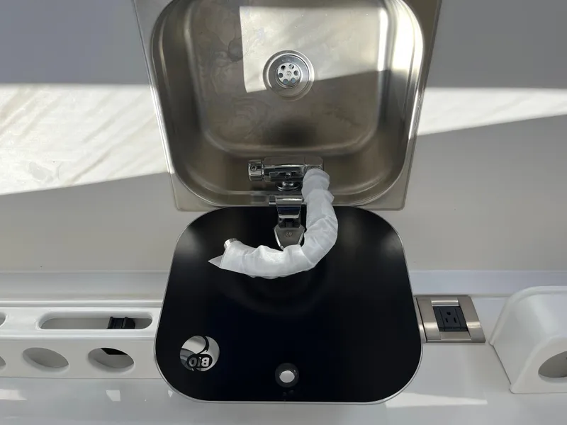 Slide: The Image of Stainless steel sink on 2024 Tuna catamaran with modern faucet and black cover. - 18