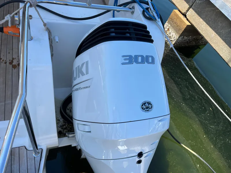 Slide: The Image of Outboard motor on 2024 Tuna catamaran, Suzuki 300 horsepower, docked by wooden pier. - 24