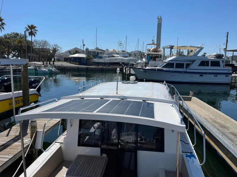 Slide: The Image of 2024 Tuna catamaran docked in marina, featuring solar panels on the roof. - 26
