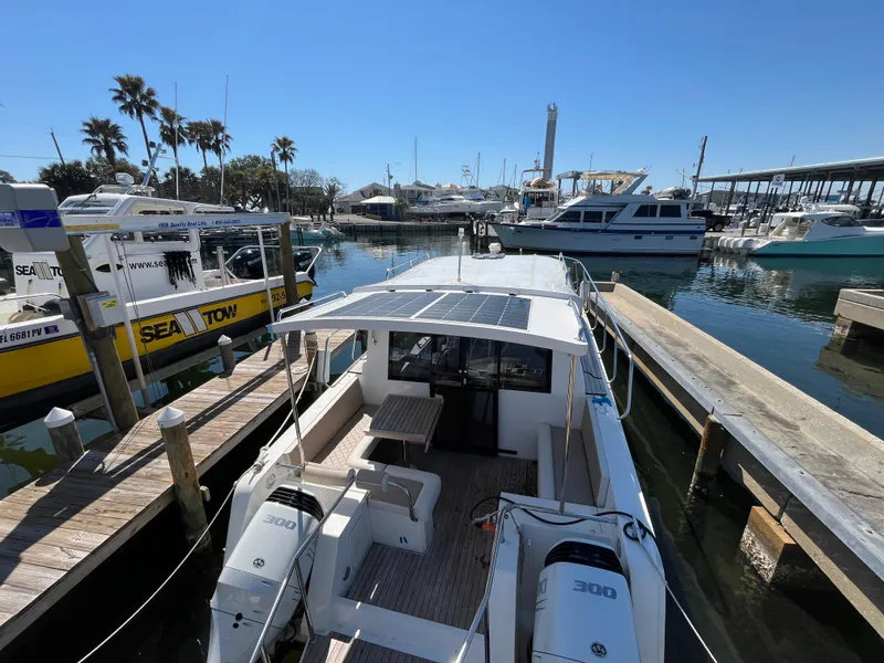 Slide: The Image of 2024 Tuna catamaran docked at marina with twin engines and solar panels. - 27