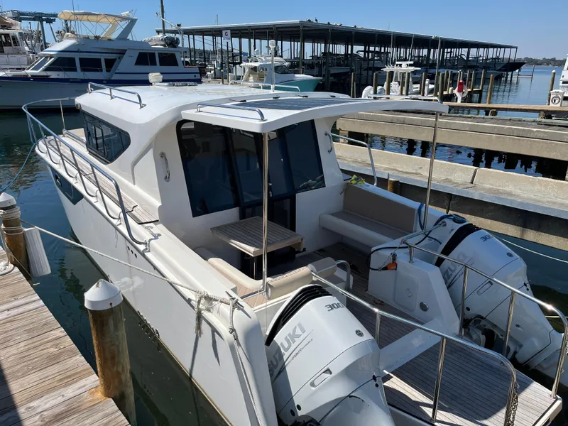 Slide: The Image of 2024 Tuna catamaran docked, featuring dual outboard engines and spacious deck area. - 3