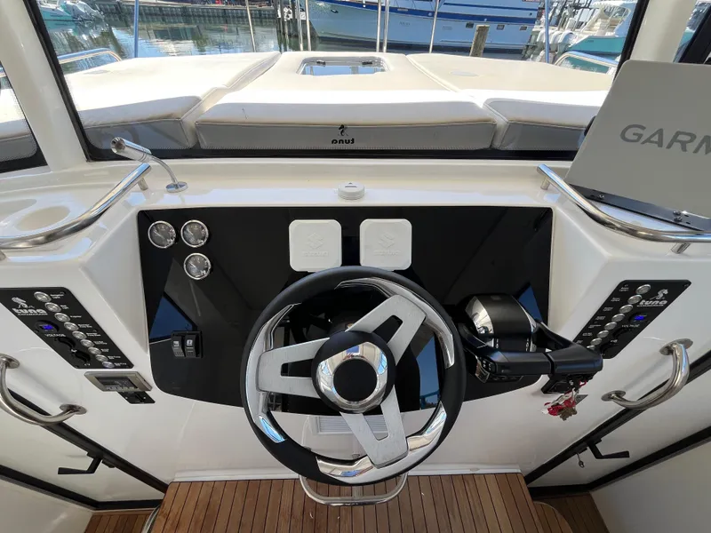 Slide: The Image of 2024 Tuna catamaran helm with modern steering wheel and navigation controls. - 5