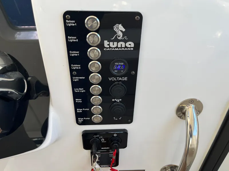 Slide: The Image of Control panel of 2024 Tuna catamaran with voltage display and labeled switches. - 6
