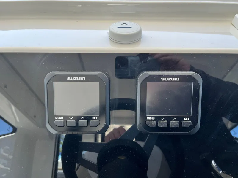 Slide: The Image of 2024 Tuna catamaran dashboard with Suzuki digital displays and steering wheel. - 8