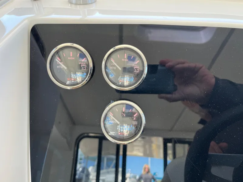 Slide: The Image of 2024 Tuna catamaran dashboard with three fuel and temperature gauges. - 9