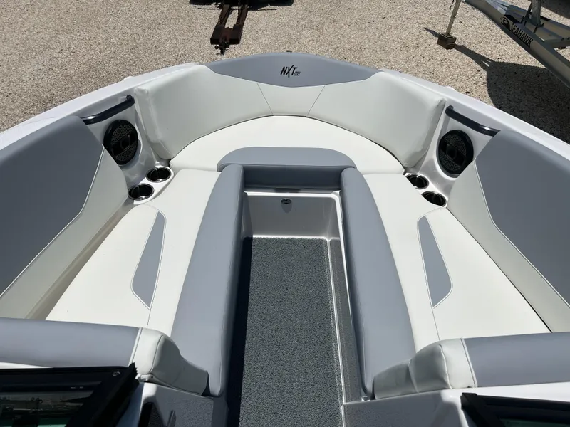 Slide: The Image of 2023 MasterCraft NXT23 boat interior with white and gray seating. - 10