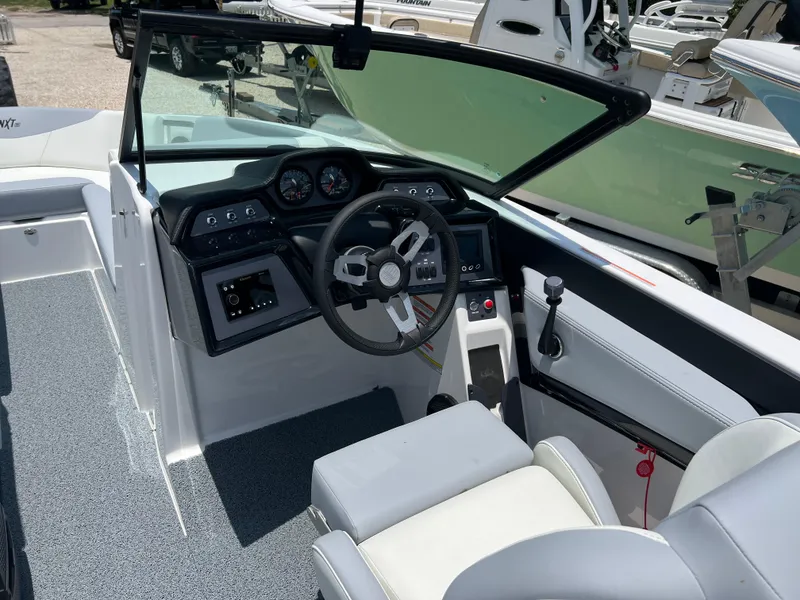 Slide: The Image of 2023 MasterCraft NXT23 boat cockpit with modern steering and controls. - 11