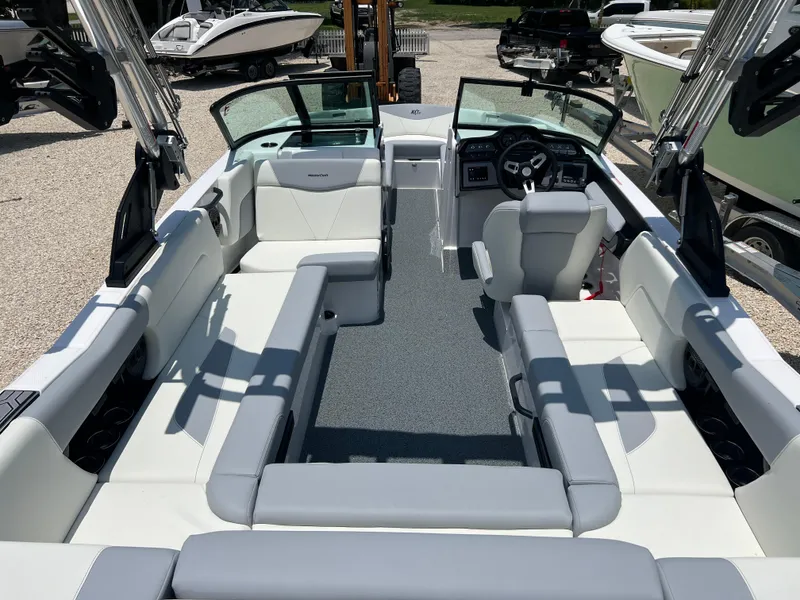 Slide: The Image of 2023 MasterCraft NXT23 boat interior with spacious seating and modern dashboard. - 3