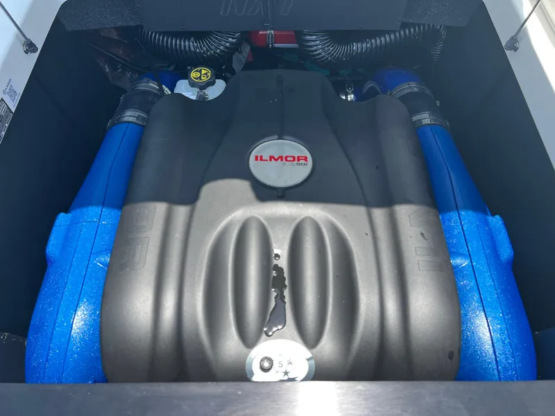 Slide: The Image of 2023 MasterCraft NXT23 Ilmor engine with blue accents in boat compartment. - 6