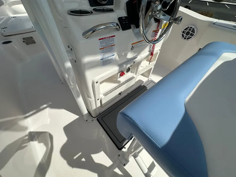 Slide: The Image of 2023 Robalo R202EX boat interior with steering wheel and blue seat. - 13