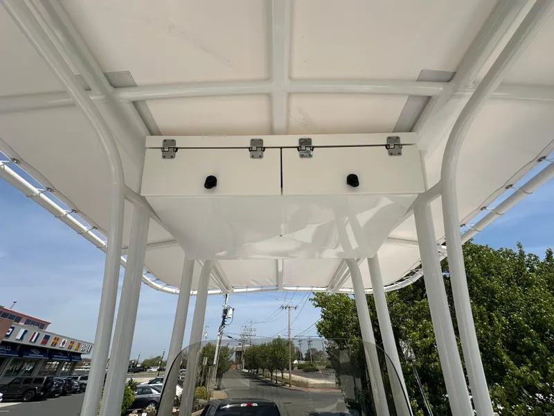 Slide: The Image of 2023 Robalo R202EX boat canopy with storage compartments, viewed from below. - 14