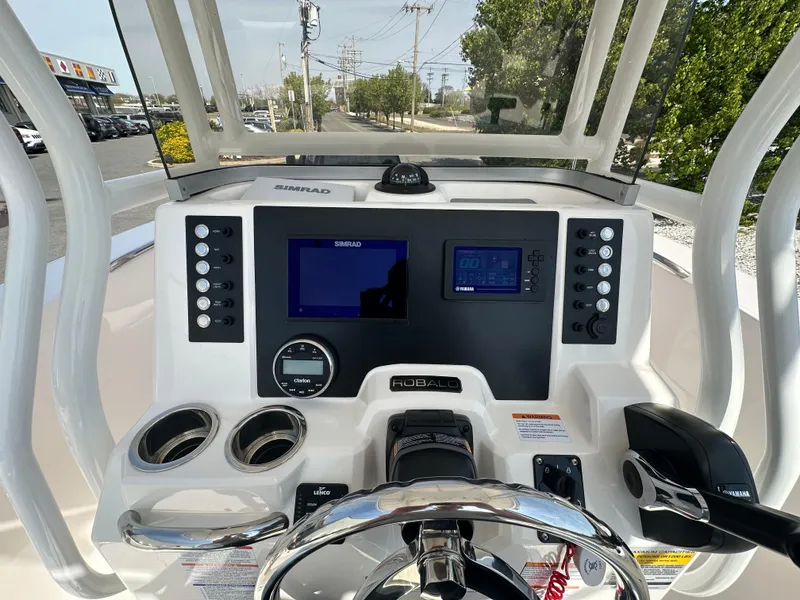 Slide: The Image of 2023 Robalo R202EX boat dashboard with steering wheel and electronic displays. - 15