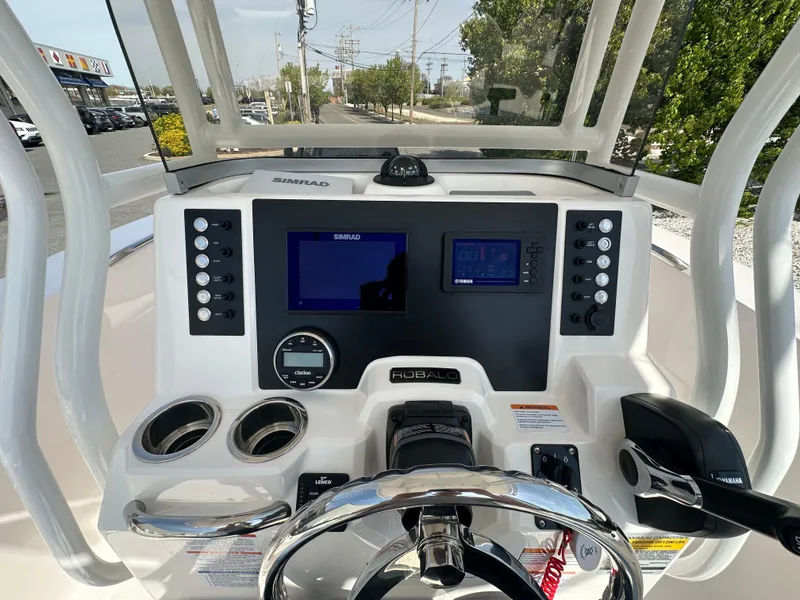 Slide: The Image of 2023 Robalo R202EX boat dashboard with navigation screens and controls. - 16
