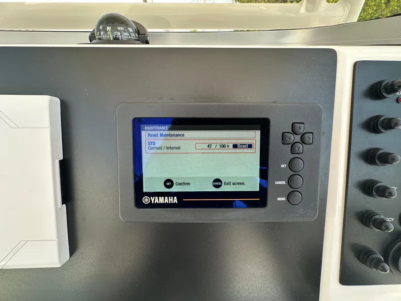 Slide: The Image of Yamaha control panel on 2023 Robalo R202EX boat dashboard, displaying maintenance settings. - 2
