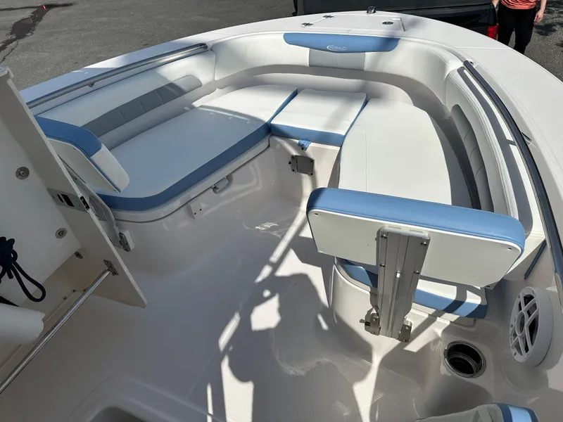 Slide: The Image of 2023 Robalo R202EX boat interior with white and blue seating arrangement. - 22