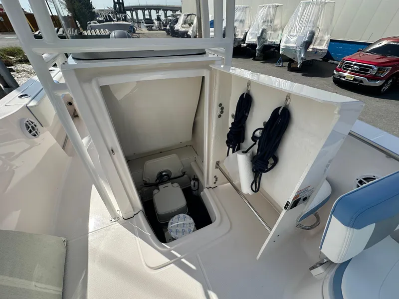 Slide: The Image of 2023 Robalo R202EX boat storage compartment with ropes and equipment. - 27