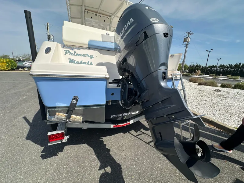 Slide: The Image of 2023 Robalo R202EX boat with Yamaha outboard motor, parked on a sunny day. - 4