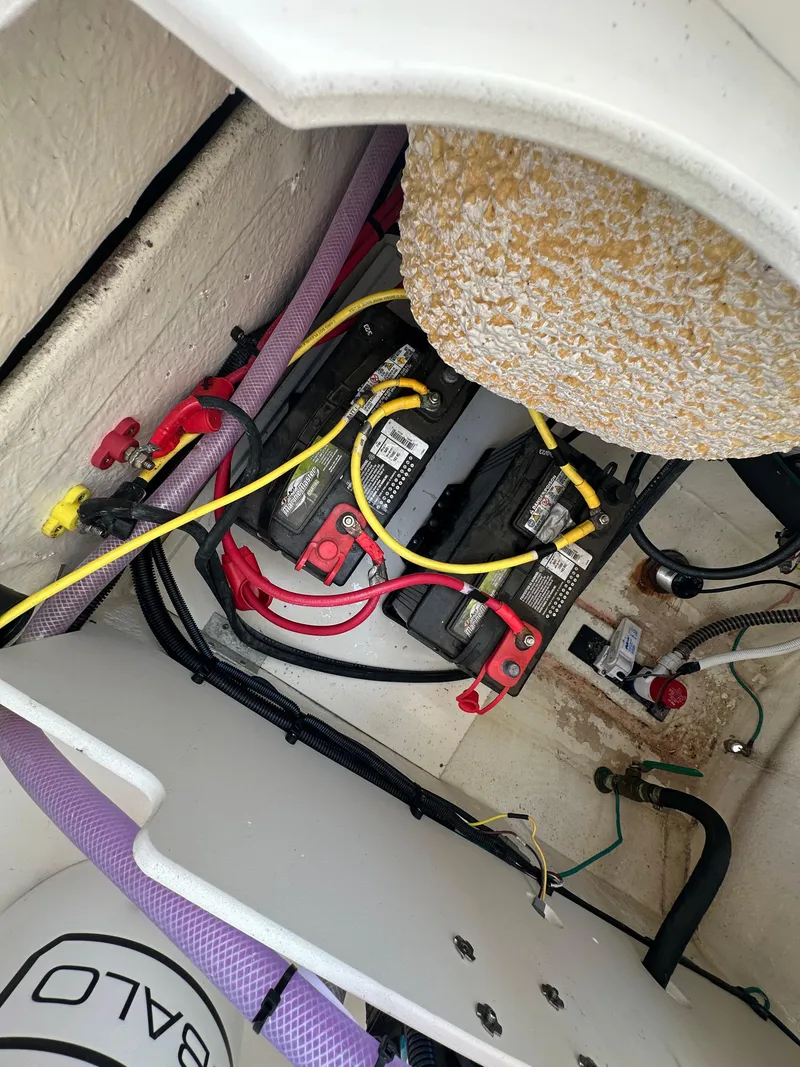 Slide: The Image of 2023 Robalo R202EX boat battery compartment with wiring and connections. - 5